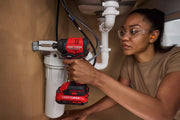 Photo of Craftsman CMCF811D1 impact driver in use under sink with plumbing visible.