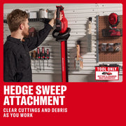 Photo of CRAFTSMAN hedge sweep attachment CMCHT830B, battery handheld tool in workshop storage, wall-mounted tools visible.