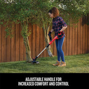 Photo of Craftsman grass trimmer CMCST900D1 in use outdoors next to a tree and wooden fence.