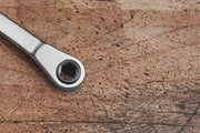 Photo of Craftsman CMHT68008 ratcheting wrench end on a scratched wooden surface.