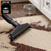 Craftsman vacuum brush attachment CMXZVBE38803 cleaning brown debris from carpet near kitchen cabinet.